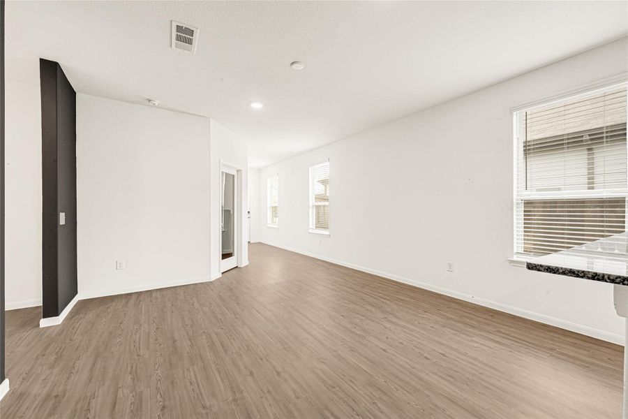 Sleek transitional space highlighting a dark accent wall contrast and a wide window design.