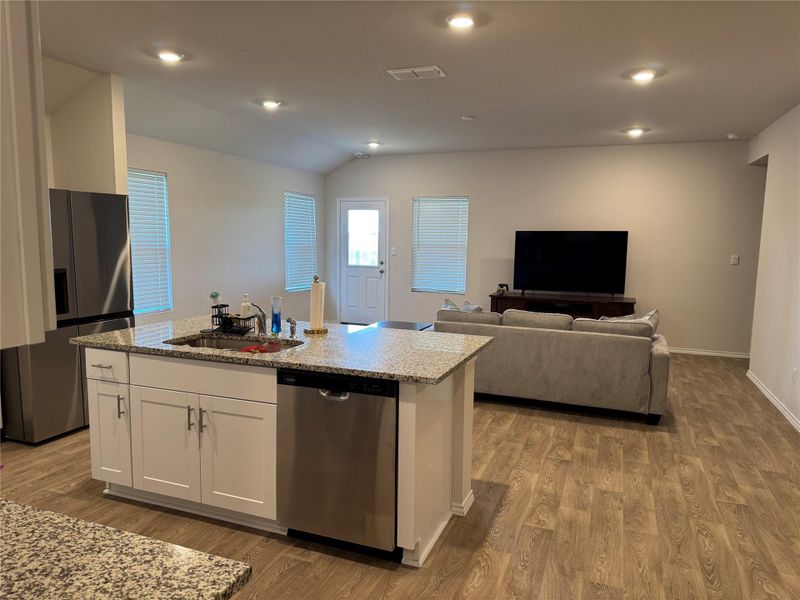 Open-concept living space with wood-finish flooring throughout