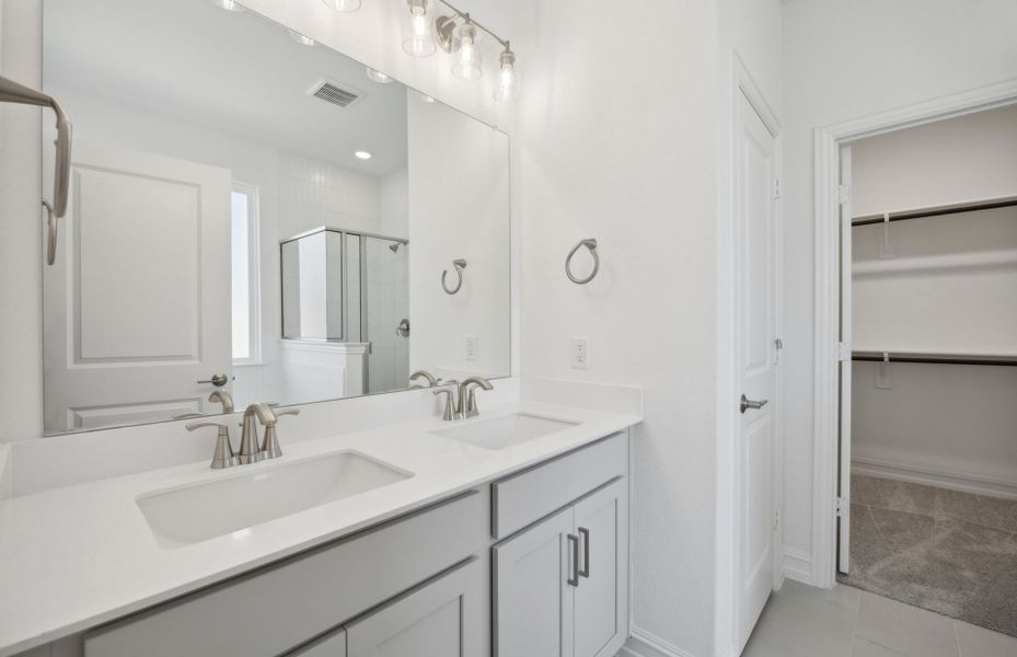 Spacious owner's bathroom with dual vanity and oversized shower