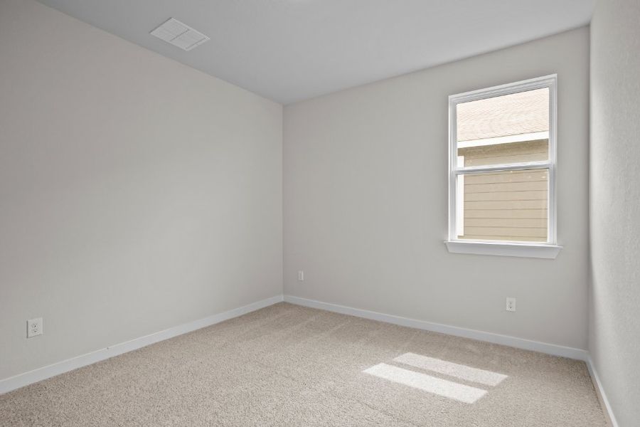 A room with a window and carpet.