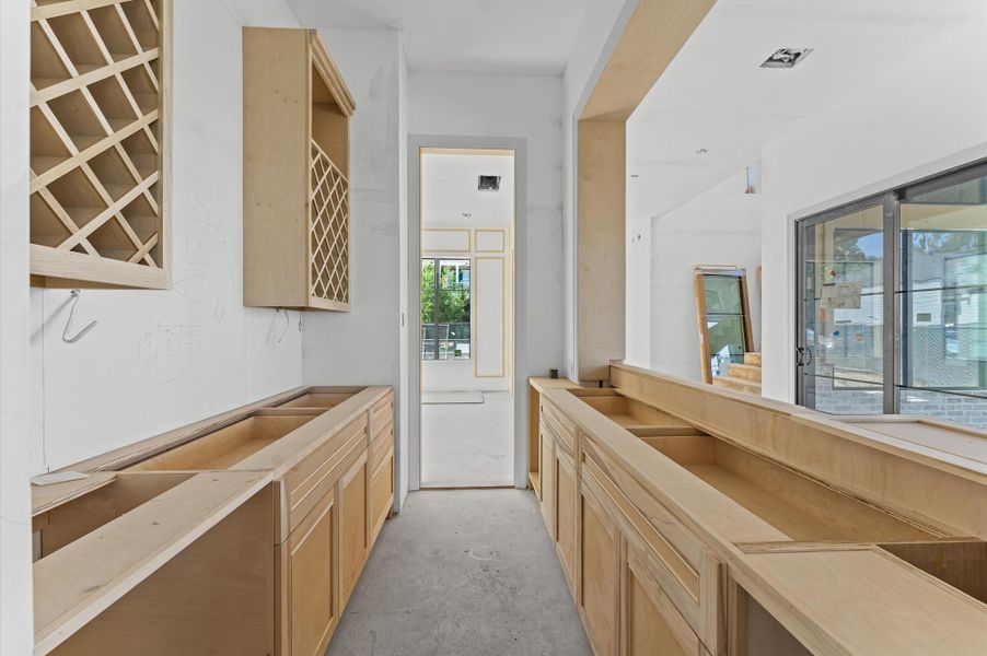 Butler's pantry and bar serve as a pass-through between the kitchen and dining room, a functional design for entertaining.