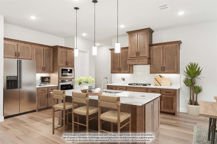 Kitchen with brown wood cabinets, center island with seating, stainless steel appliances, and pendant lights