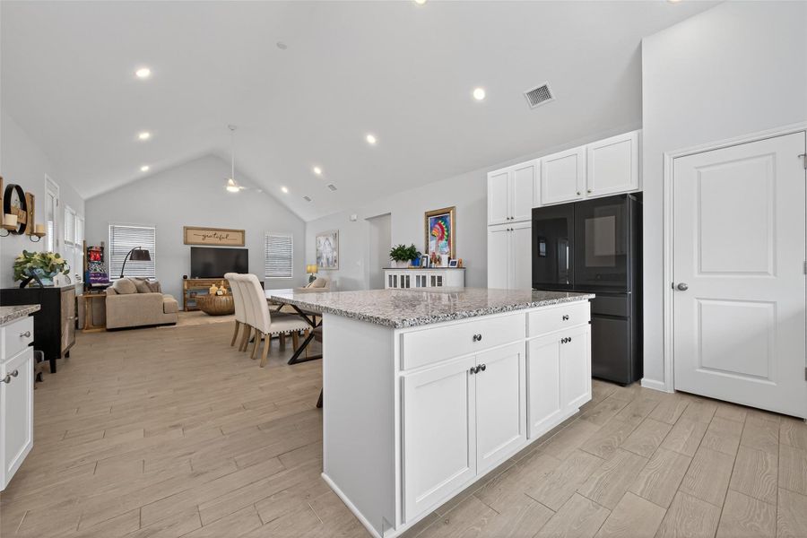 Well-designed kitchen with an expansive island and breakfast bar, offering ample workspace within an open floor plan