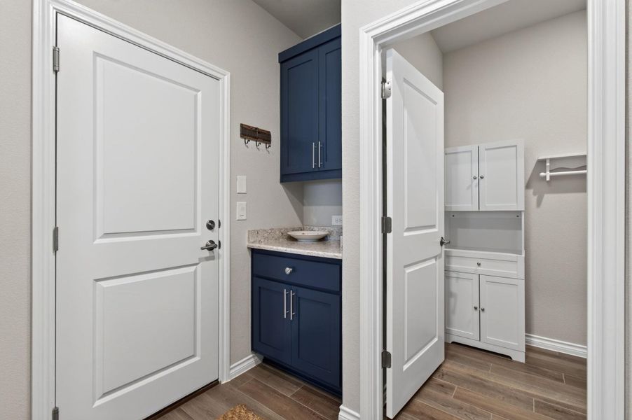 A well-appointed laundry area offers convenient storage and easy access to an adjoining space. A well-appointed laundry area offers convenient storage and easy access to an adjoining space.