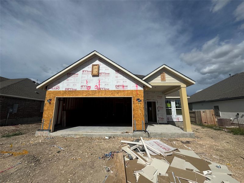Front exterior of a new home in Village at Three Oaks, Seguin, TX, highlighting curb appeal (Image 9).