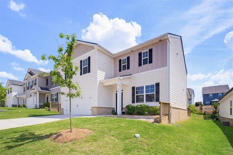 Front exterior of a new home in Twin Lakes, Hoschton, GA, highlighting curb appeal (Image 26). Front exterior of a new home in Twin Lakes, Hoschton, GA, highlighting curb appeal (Image 26).