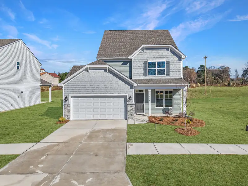 Front exterior of a new home in Monterra, Kernersville, NC, highlighting curb appeal (Image 1). Front exterior of a new home in Monterra, Kernersville, NC, highlighting curb appeal (Image 1).