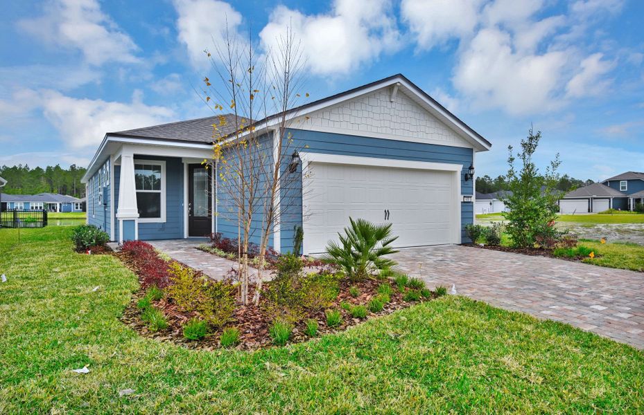 Front exterior of a new home in Del Webb Wildlight, Wildlight, FL, highlighting curb appeal (Image 23).