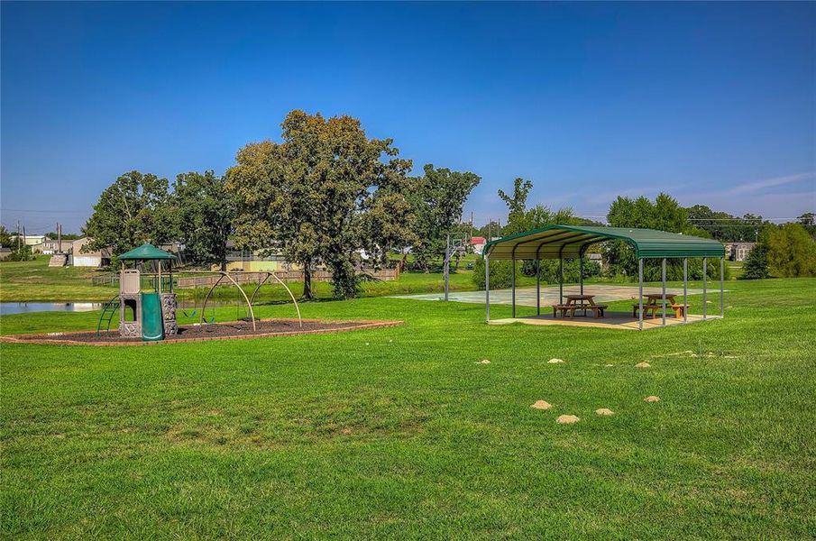 Communal playground with a lawn and a patio area