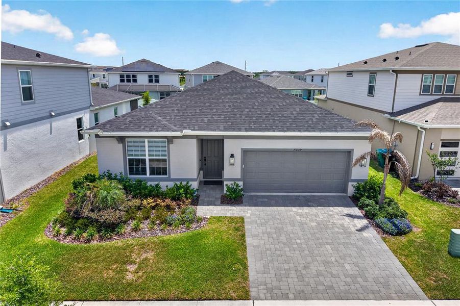 Front exterior of a new home in EverBe, Orlando, FL, highlighting curb appeal (Image 1). Front exterior of a new home in EverBe, Orlando, FL, highlighting curb appeal (Image 1).