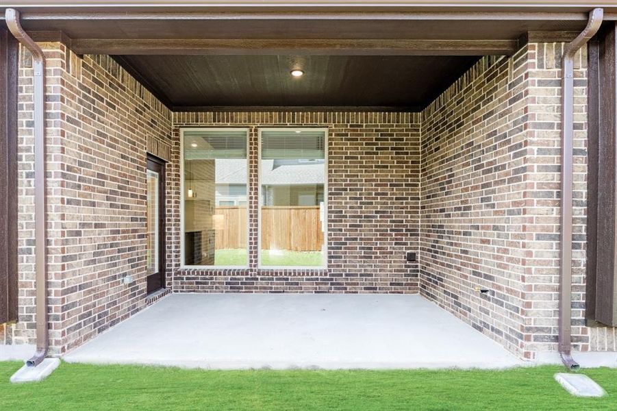Exterior details and patio area of a home in Woodstone, Providence Village (Image 26).