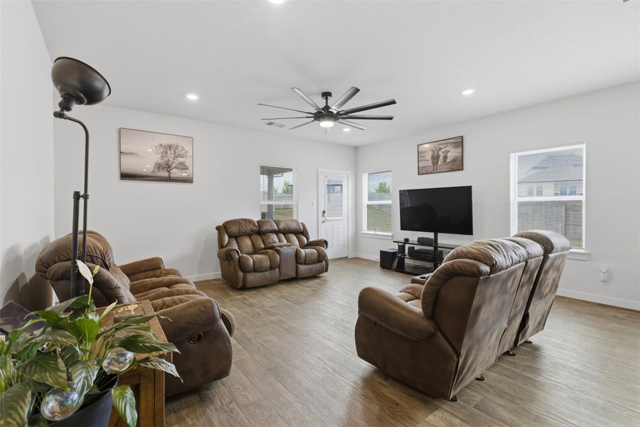 Living area featuring wood finished floors, recessed lighting, and ceiling fan
