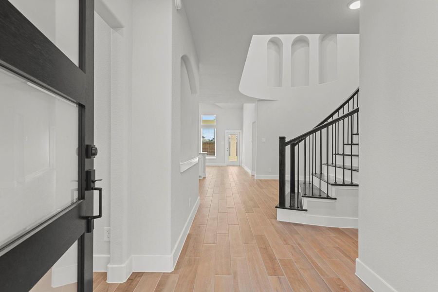 Enter through the beautiful front door and be greeted by a grand two-story foyer that sets the tone for what’s ahead. The open sightlines, high ceilings, and sweeping staircase showcase the San Marcos Floor Plan’s dramatic architecture and modern flow.