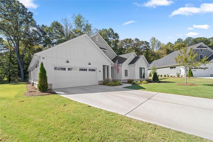 Front exterior of a new home in The Courtyards by The Manor, Alpharetta, GA, highlighting curb appeal (Image 1). Front exterior of a new home in The Courtyards by The Manor, Alpharetta, GA, highlighting curb appeal (Image 1).