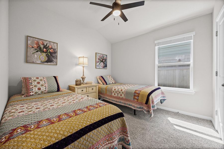 Vaulted ceilings and plush carpeting enhance this serene bedroom layout.