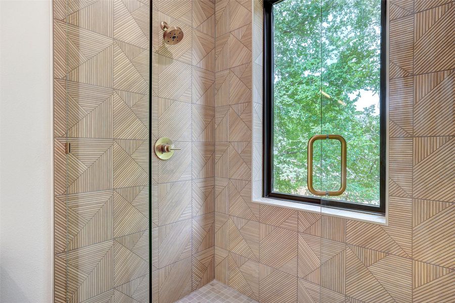Bathroom with plenty of natural light and a tile shower Bathroom with plenty of natural light and a tile shower