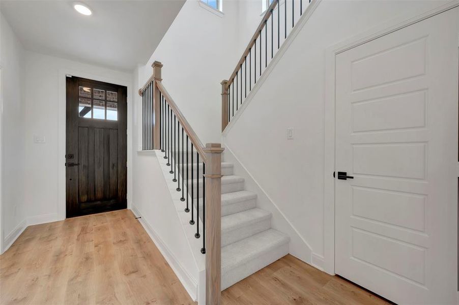 Foyer entrance featuring light wood-type flooring and stairway