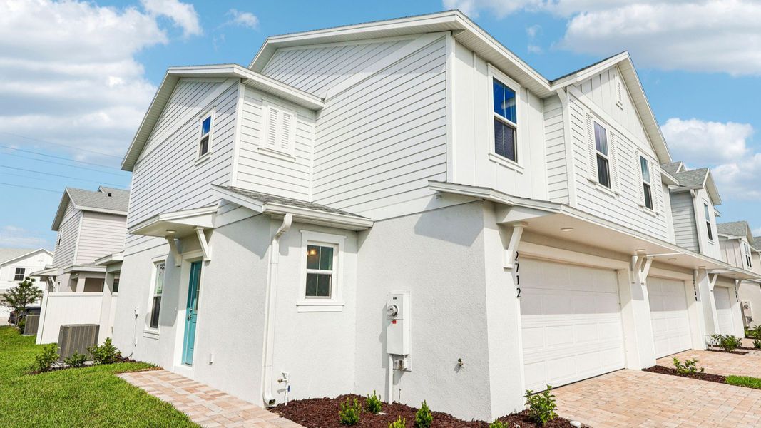 Front exterior of a new home in Cyrene at Harmony, St. Cloud, FL, highlighting curb appeal (Image 2).