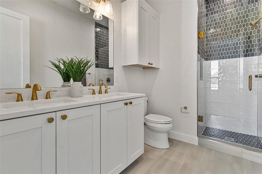 Bathroom with vanity, tile patterned flooring, toilet, and walk in shower