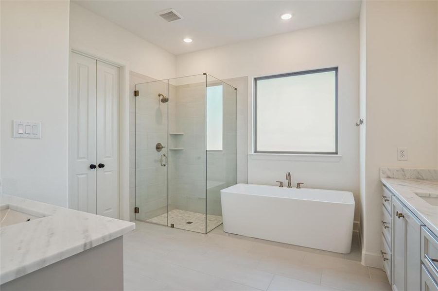 Bathroom with shower with separate bathtub, vanity, and tile patterned floors