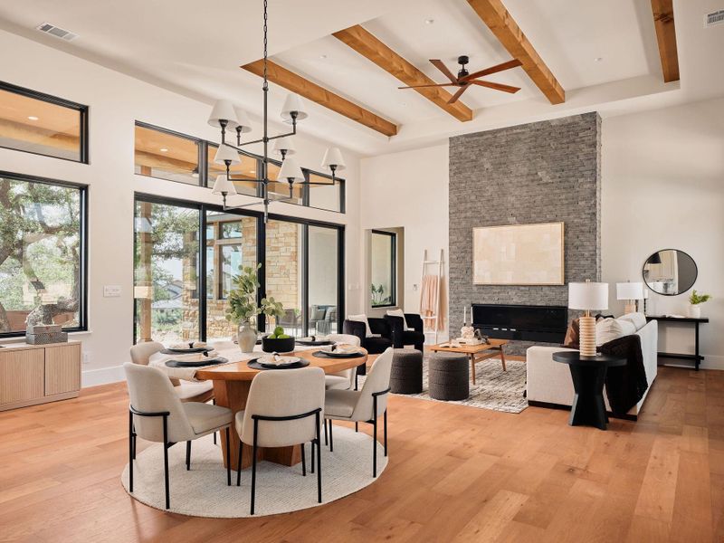 Natural light streams into this expansive living area, highlighting high ceilings with exposed beams and hardwood flooring. Natural light streams into this expansive living area, highlighting high ceilings with exposed beams and hardwood flooring.