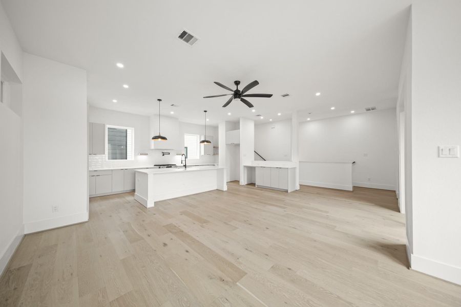 Imagine relaxing or entertaining family and friends in the family room with recessed lights and a ceiling fan, offering numerous furniture placement opportunities.