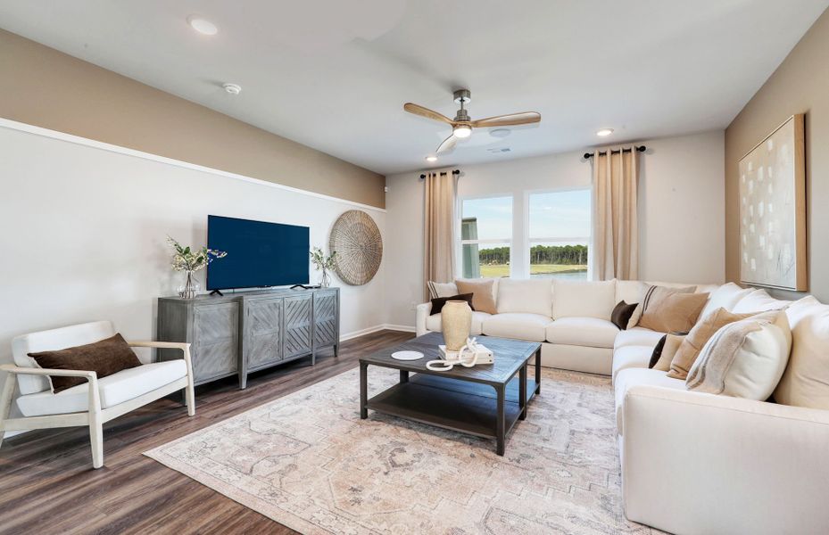 Spacious Gathering Room with large window adding plenty of natural light to the entertaining space.