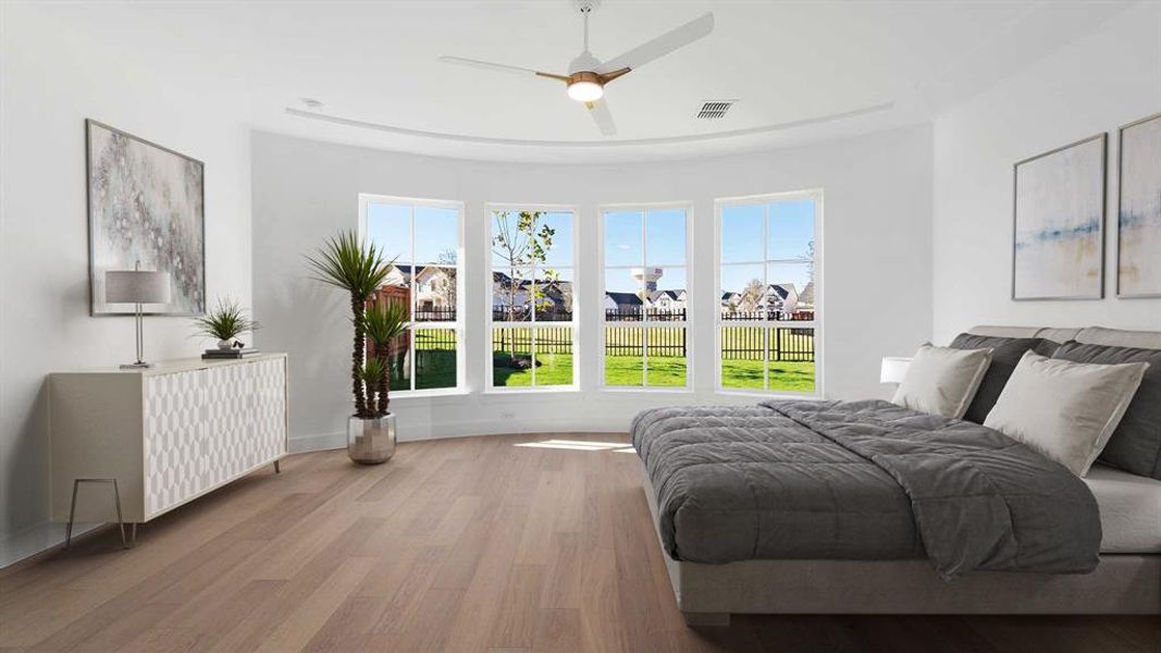 Bedroom featuring ceiling fan and light hardwood / wood-style flooring