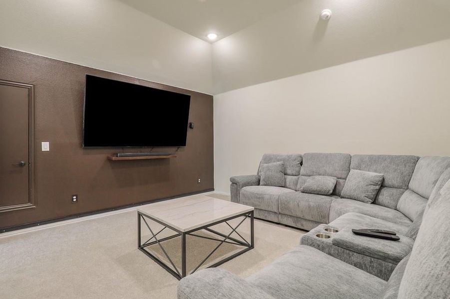 Living room with light carpet and lofted ceiling
