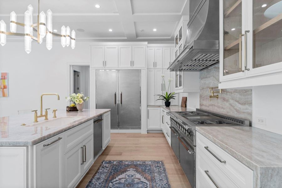 The chef's kitchen features a 6-burner gas stove and stunning pendant lighting The chef's kitchen features a 6-burner gas stove and stunning pendant lighting