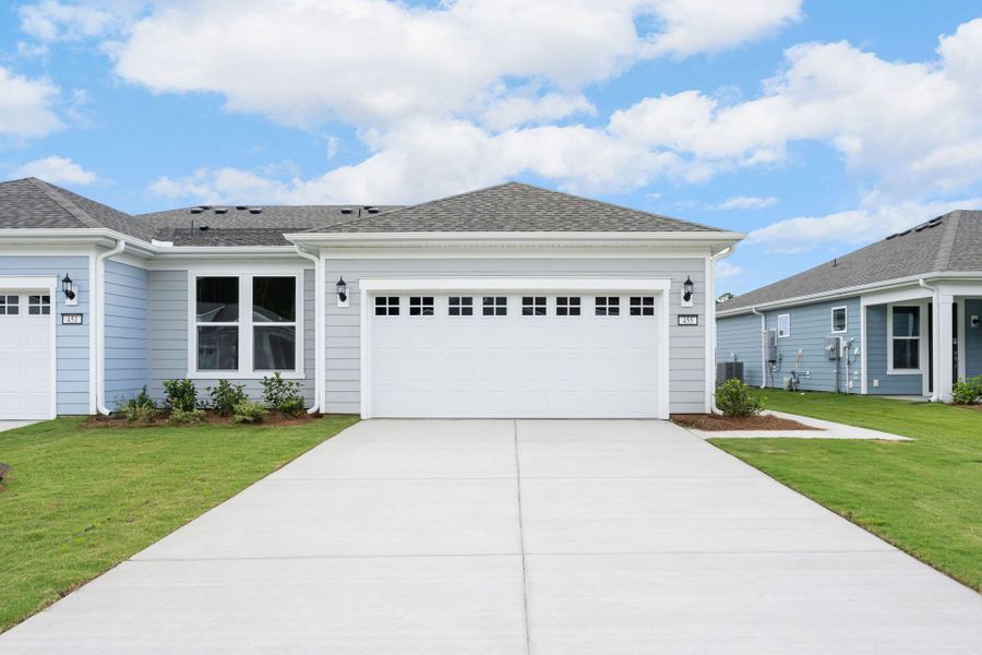 Front exterior of a new home in Sun City Hilton Head, Bluffton, SC, highlighting curb appeal (Image 1). Front exterior of a new home in Sun City Hilton Head, Bluffton, SC, highlighting curb appeal (Image 1).