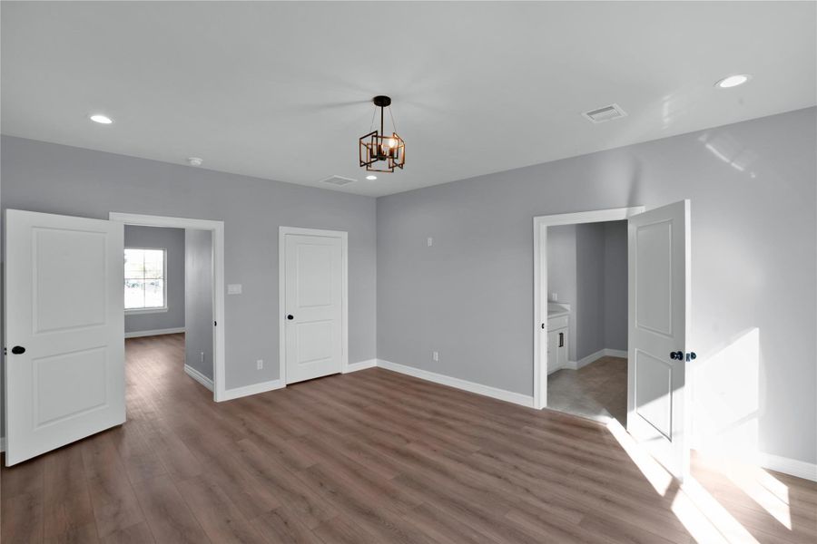 Another view of the primary bedroom leading into the secondary closet and your en-suite bath