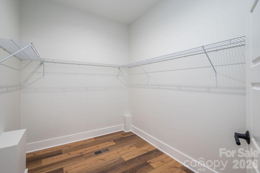 Larger of two walk-in closets in primary bedroom