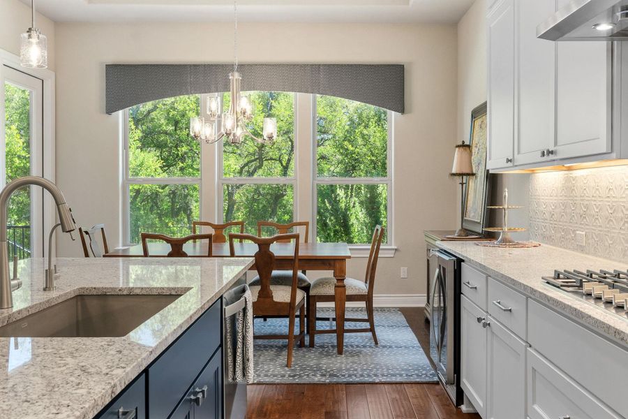 Granite countertops and designer backsplash tile elevate the design. Granite countertops and designer backsplash tile elevate the design.