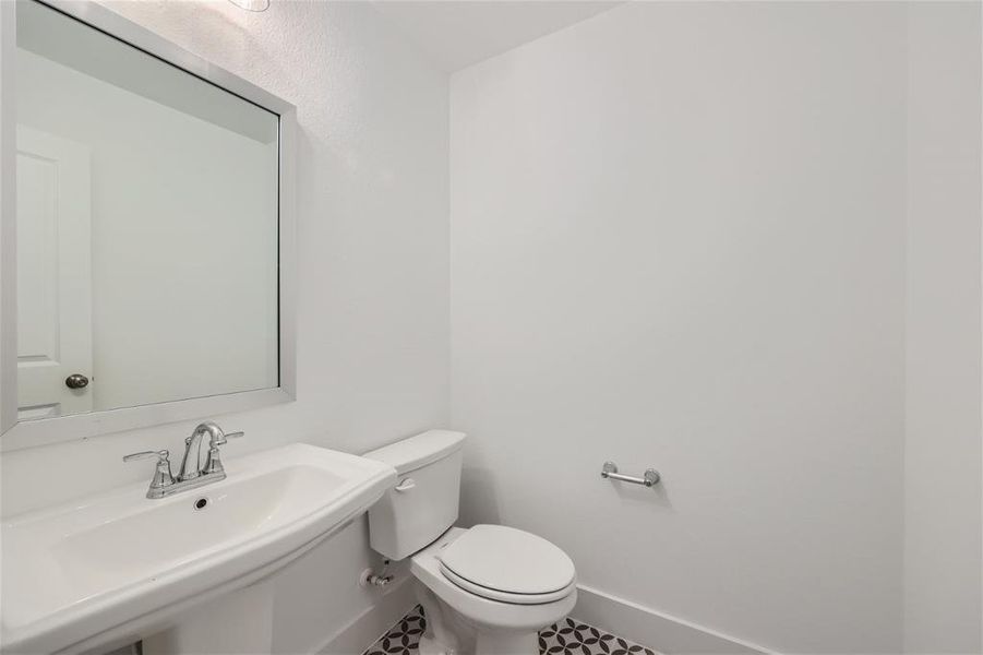 Bathroom with sink, toilet, and tile floors