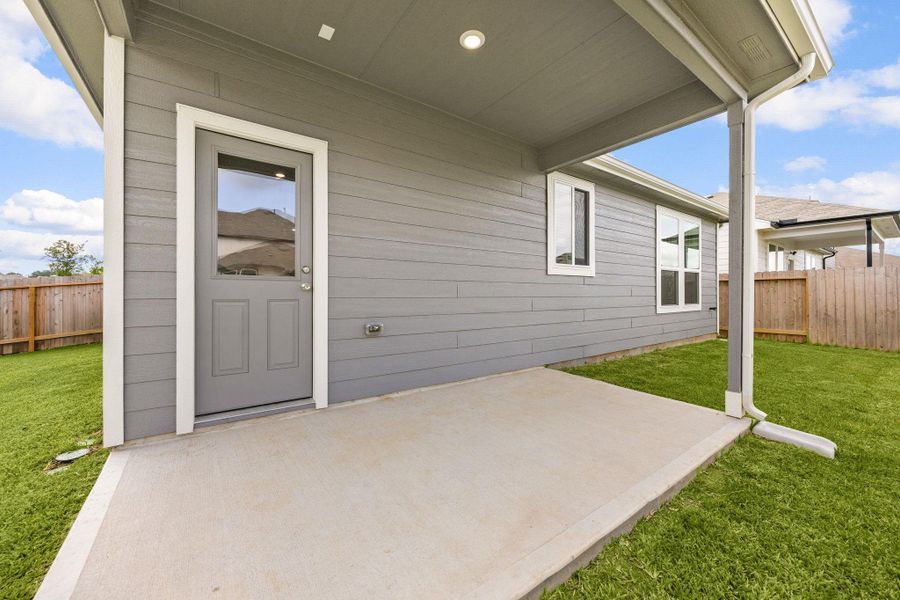 Covered back patio offers the perfect space for morning coffee, outdoor dining, or relaxing while enjoying the backyard.