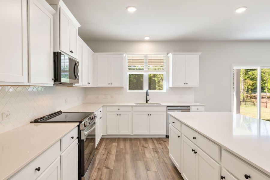 A kitchen with white cabinets. A kitchen with white cabinets.