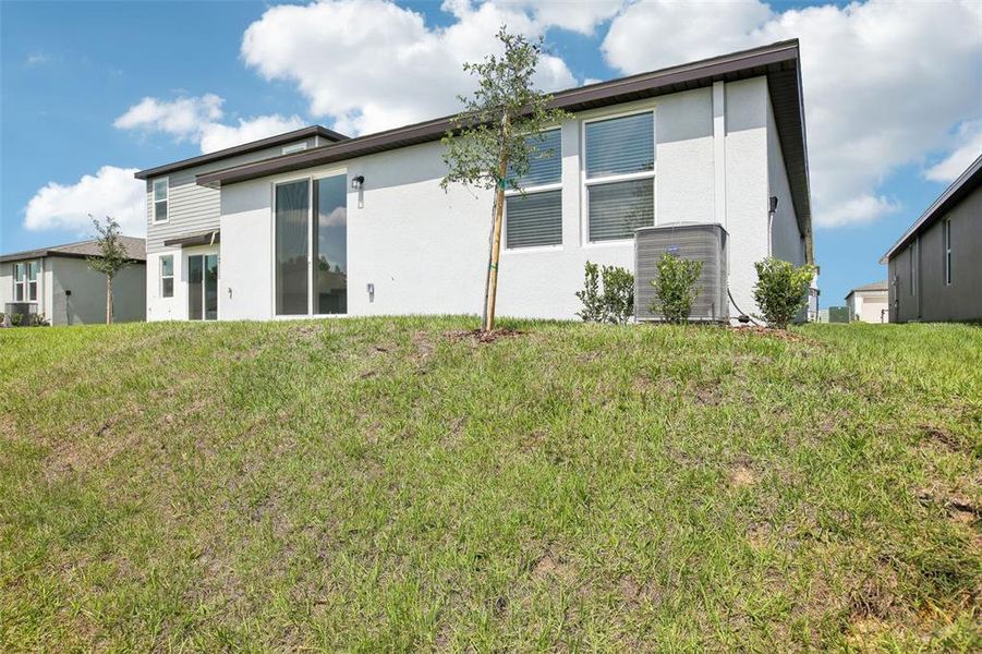 Front exterior of a new home in Benton Hills - Classic Series, Brooksville, FL, highlighting curb appeal (Image 16). Front exterior of a new home in Benton Hills - Classic Series, Brooksville, FL, highlighting curb appeal (Image 16).