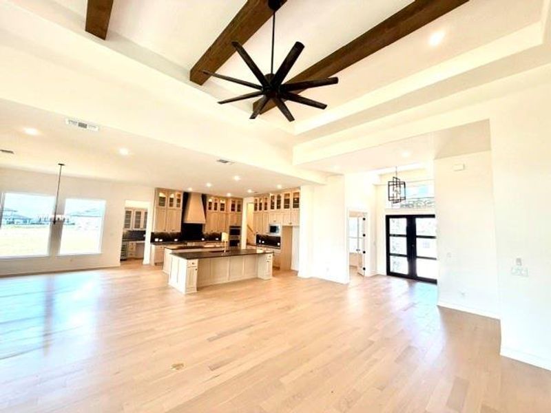 A spacious, open-concept living area with soaring ceilings and a contemporary kitchen. A spacious, open-concept living area with soaring ceilings and a contemporary kitchen.