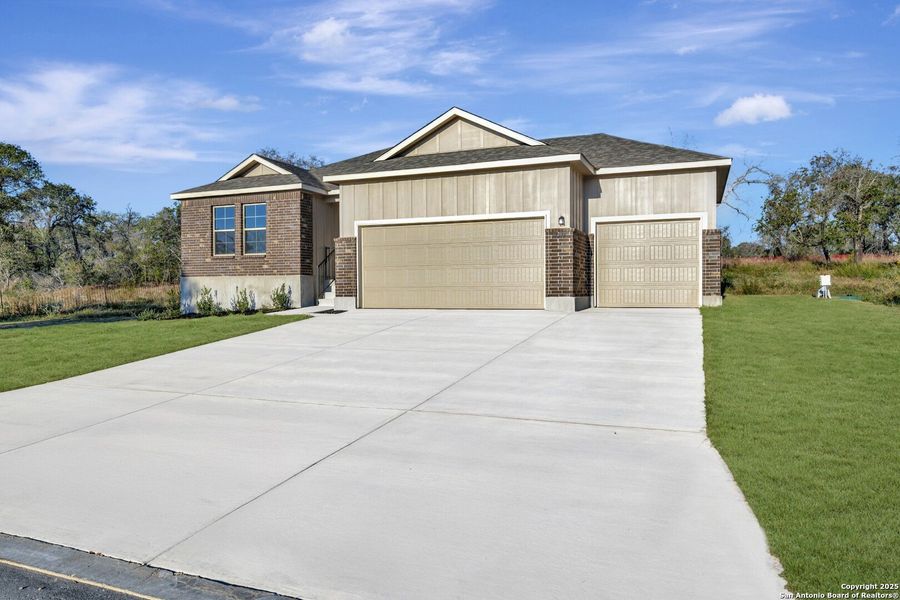 Front exterior of a new home in Jordan's Ranch, San Antonio, TX, highlighting curb appeal (Image 2). Front exterior of a new home in Jordan's Ranch, San Antonio, TX, highlighting curb appeal (Image 2).
