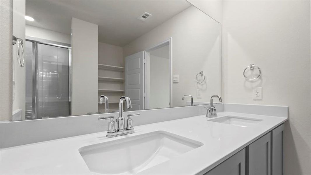 Full bathroom featuring double vanity and a shower stall Full bathroom featuring double vanity and a shower stall