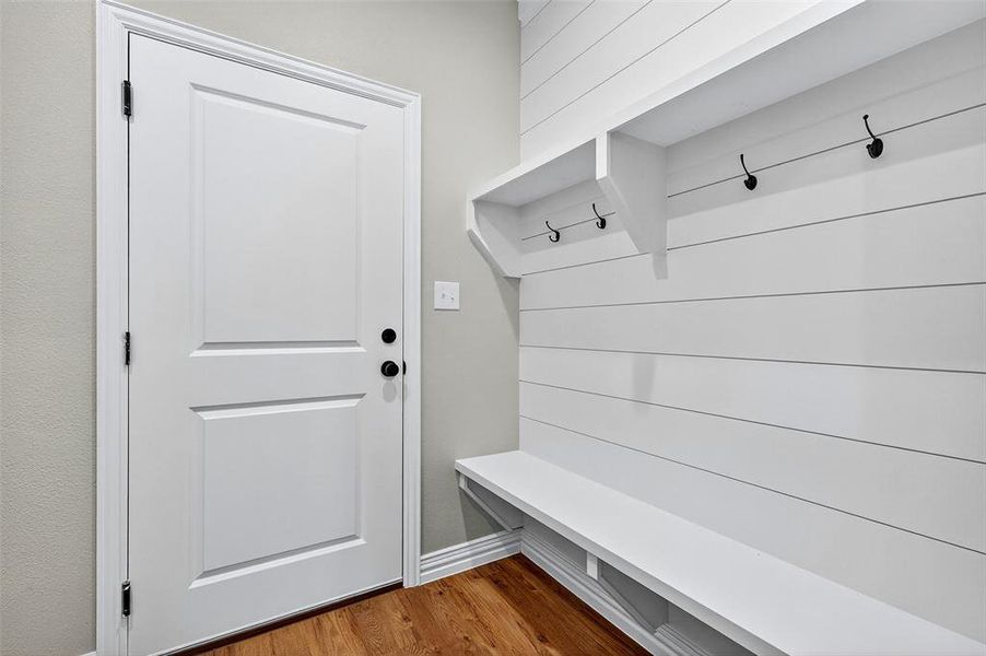 Mudroom featuring wood finished floors and baseboards Mudroom featuring wood finished floors and baseboards
