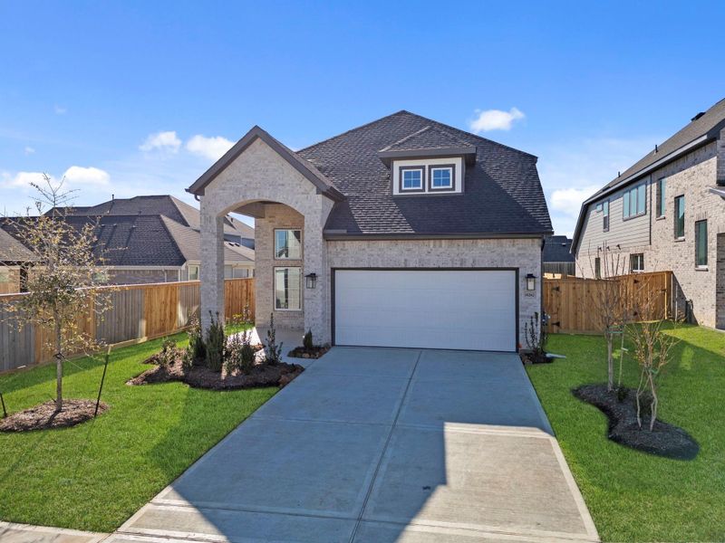 Front exterior of a new home in Emory Glen, Magnolia, TX, highlighting curb appeal (Image 20).