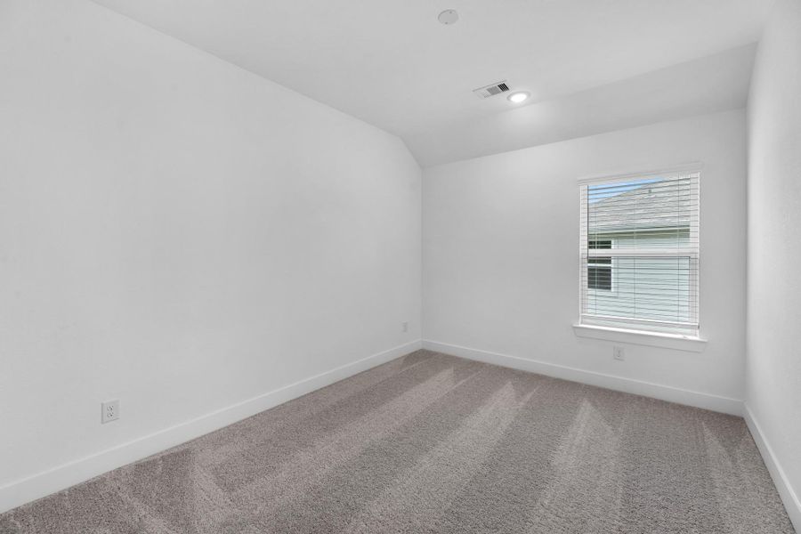 Your secondary bedroom features plush carpet, fresh paint, and a large window that lets in plenty of natural lighting.