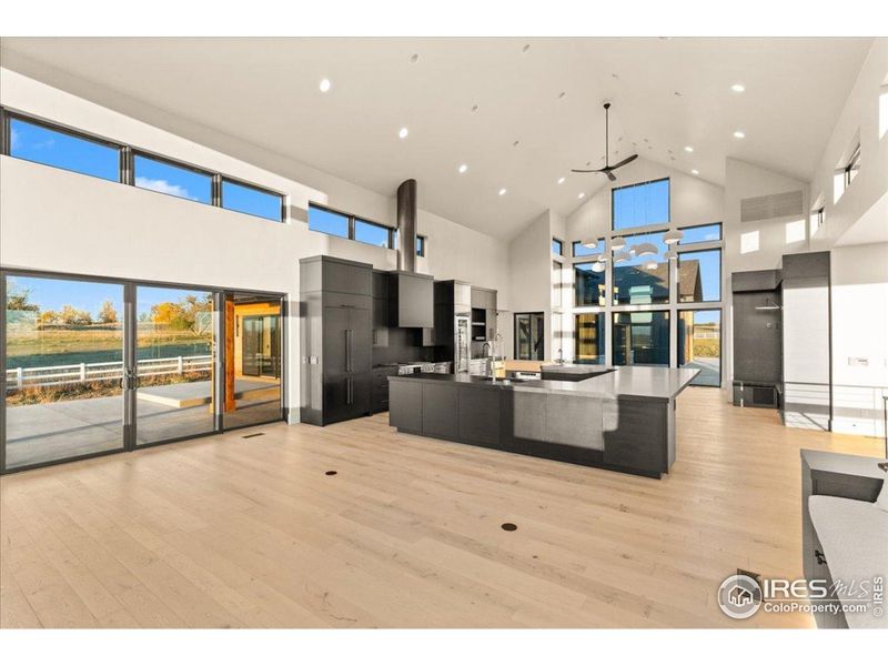 Great room w/ 28' ceiling height, engineered hardwood floors