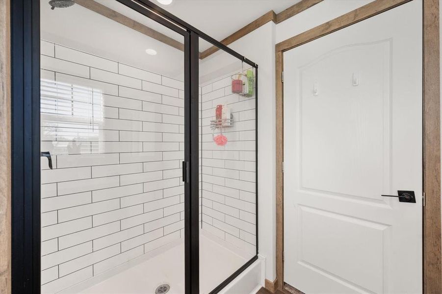Full bathroom featuring a shower stall Full bathroom featuring a shower stall