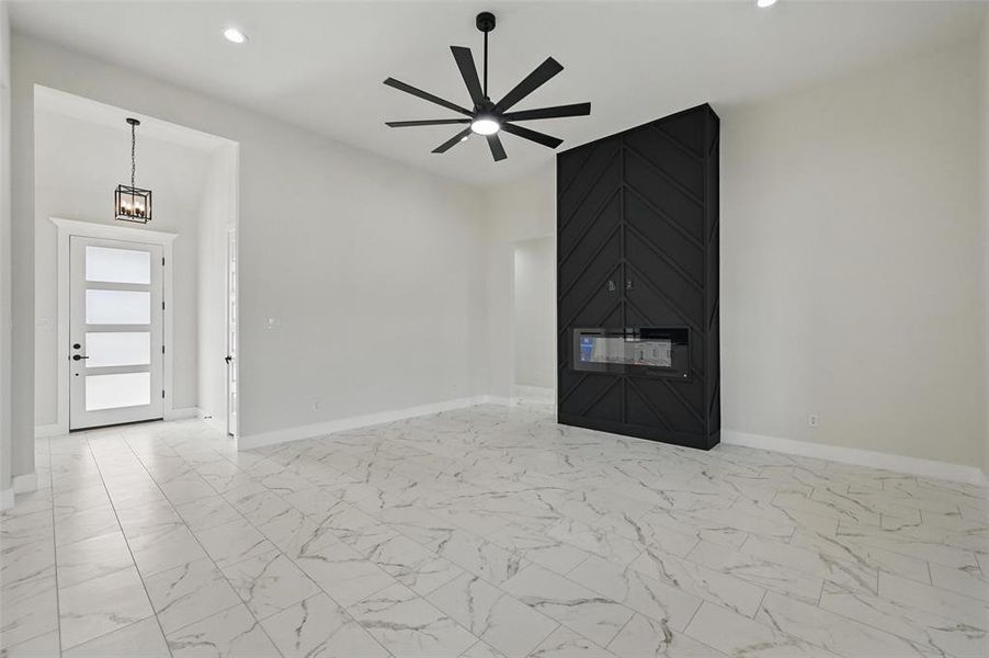Unfurnished living room featuring baseboards, a ceiling fan, light marble finish floors, and recessed lighting Unfurnished living room featuring baseboards, a ceiling fan, light marble finish floors, and recessed lighting