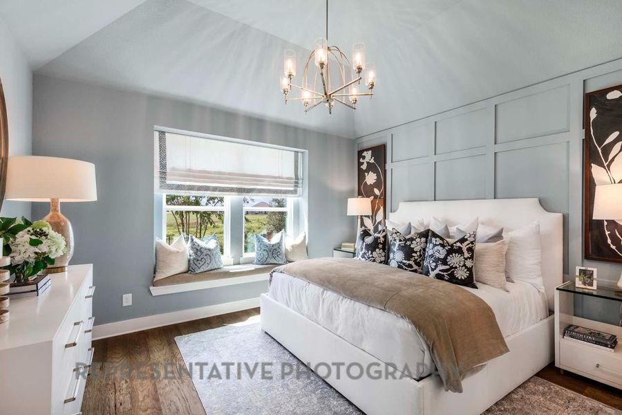 Bedroom with a chandelier, dark wood finished floors, and vaulted ceiling Bedroom with a chandelier, dark wood finished floors, and vaulted ceiling