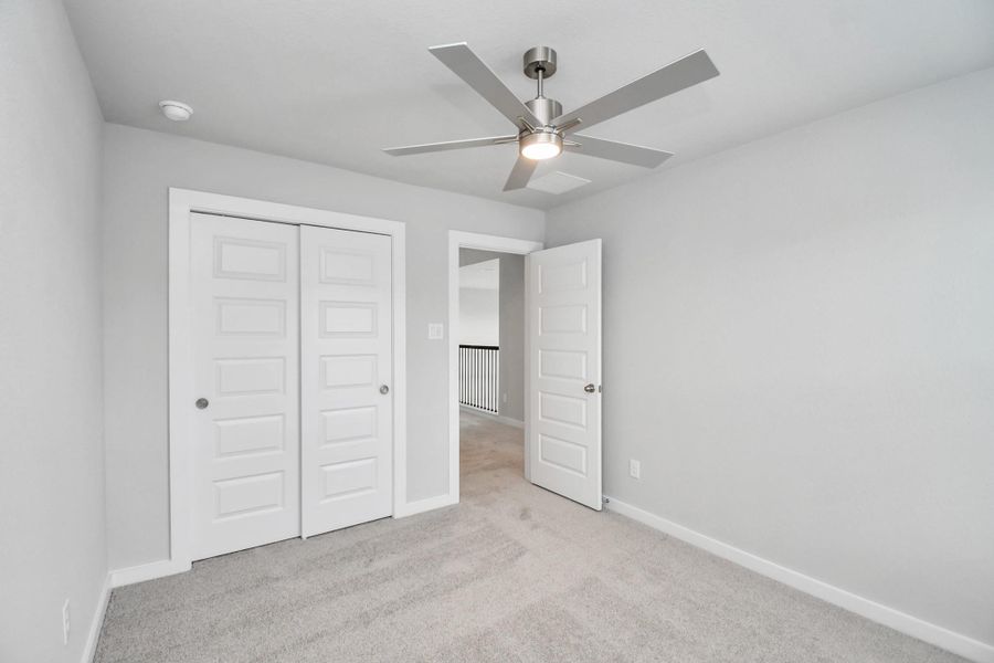 Generously sized secondary bedrooms featuring spacious closets, soft and inviting carpeting underfoot, large windows allowing plenty of natural light, and the added touch of privacy blinds for your personal retreat. Sample photo of completed home with similar floor plan. Actual colors and selections may vary. Generously sized secondary bedrooms featuring spacious closets, soft and inviting carpeting underfoot, large windows allowing plenty of natural light, and the added touch of privacy blinds for your personal retreat. Sample photo of completed home with similar floor plan. Actual colors and selections may vary.