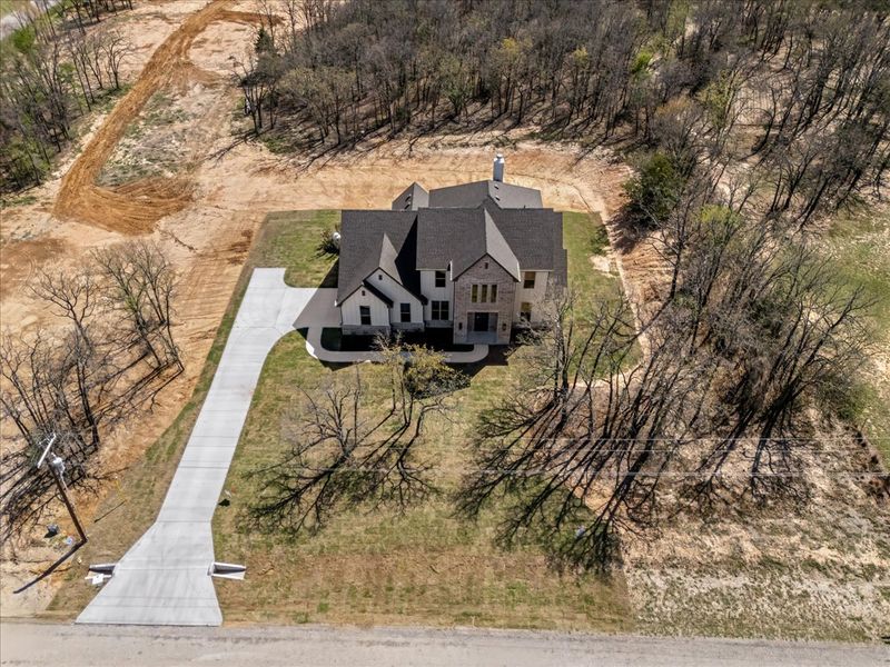 Front exterior of a new home in Spring Valley Ranch, Paradise, TX, highlighting curb appeal (Image 26). Front exterior of a new home in Spring Valley Ranch, Paradise, TX, highlighting curb appeal (Image 26).